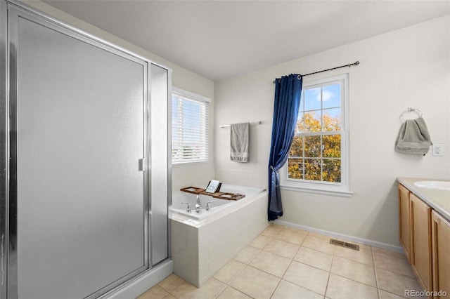 bathroom with tile patterned floors, separate shower and tub, and vanity