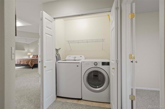 laundry room featuring light colored carpet and independent washer and dryer