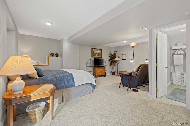 bedroom with carpet floors and connected bathroom