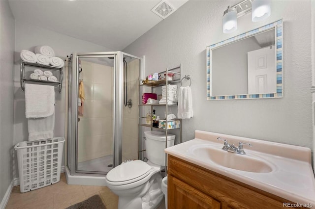 bathroom featuring tile patterned flooring, vanity, a shower with shower door, and toilet