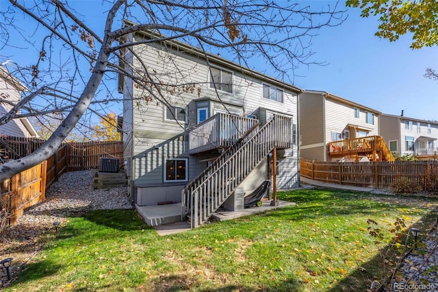 back of property with a lawn and central AC unit