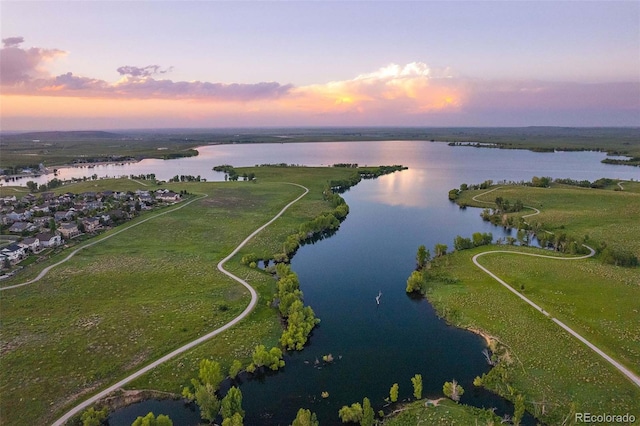 aerial view at dusk with a water view