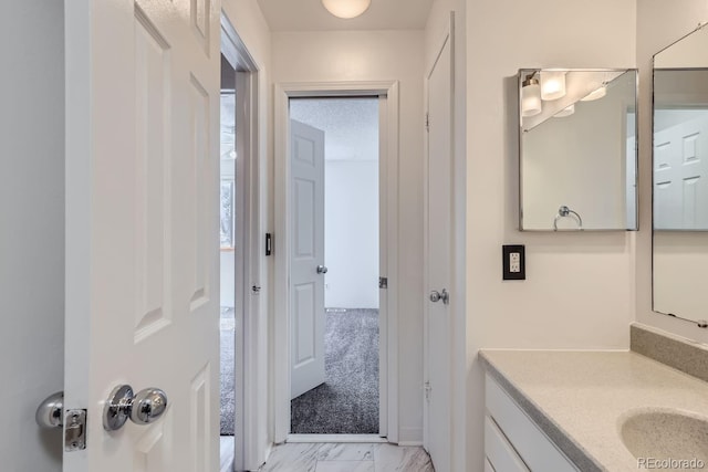 bathroom featuring marble finish floor and vanity