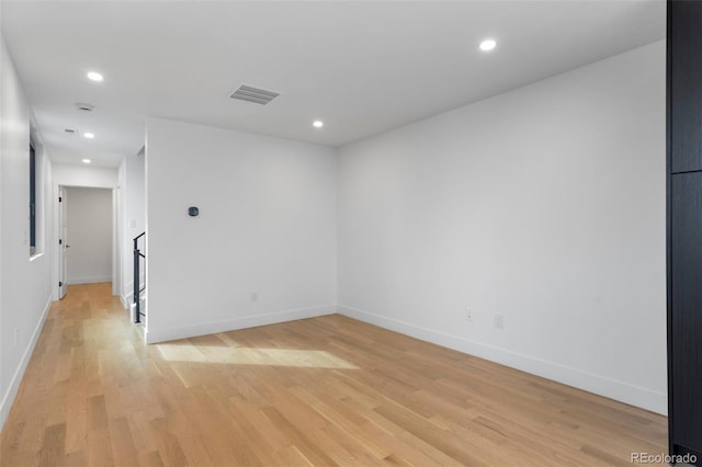 unfurnished room with light wood-style floors, recessed lighting, visible vents, and baseboards