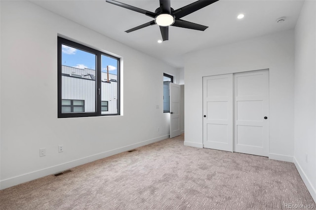 unfurnished bedroom with recessed lighting, visible vents, baseboards, a closet, and carpet