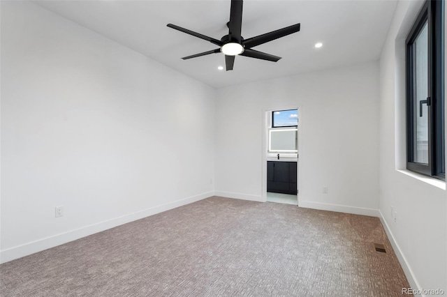 carpeted spare room with a ceiling fan, recessed lighting, visible vents, and baseboards