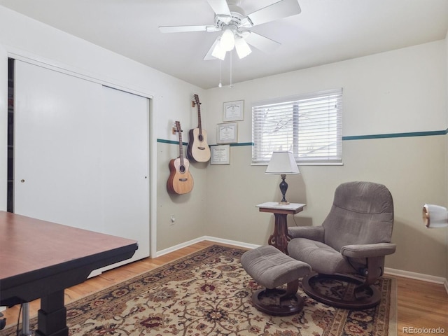 living area featuring hardwood / wood-style flooring and ceiling fan