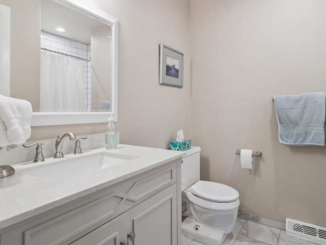 bathroom featuring vanity, toilet, and curtained shower