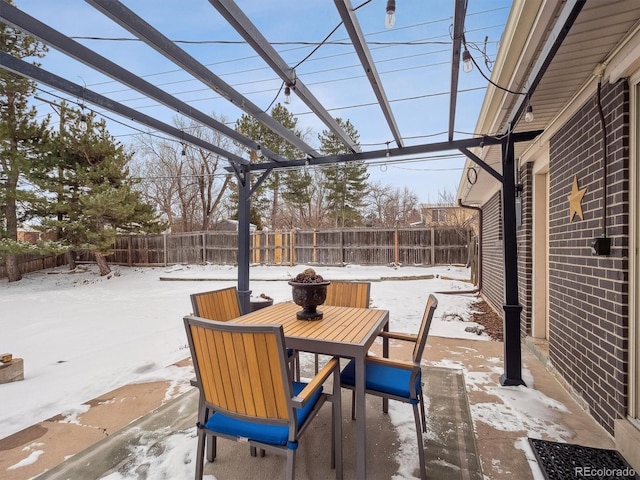 snow covered patio with a pergola