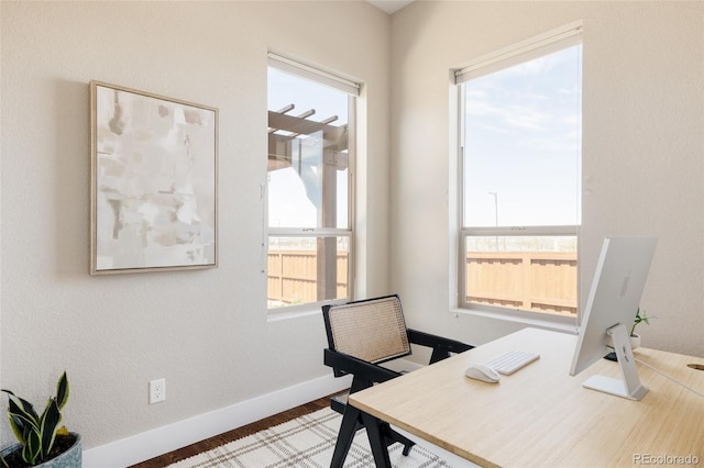 office area featuring baseboards and wood finished floors