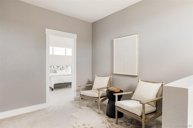 living area with baseboards and carpet flooring