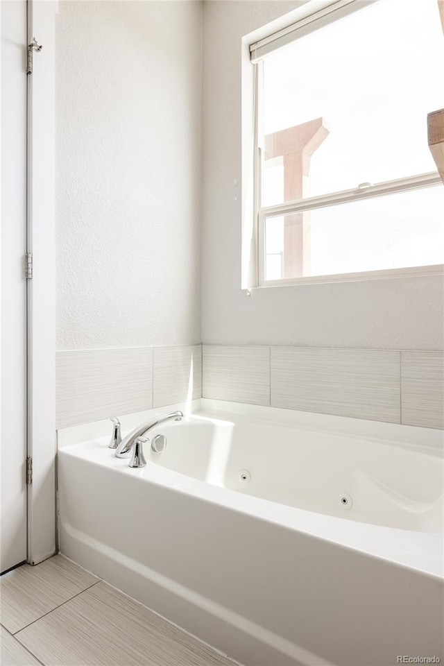 full bathroom featuring a tub with jets