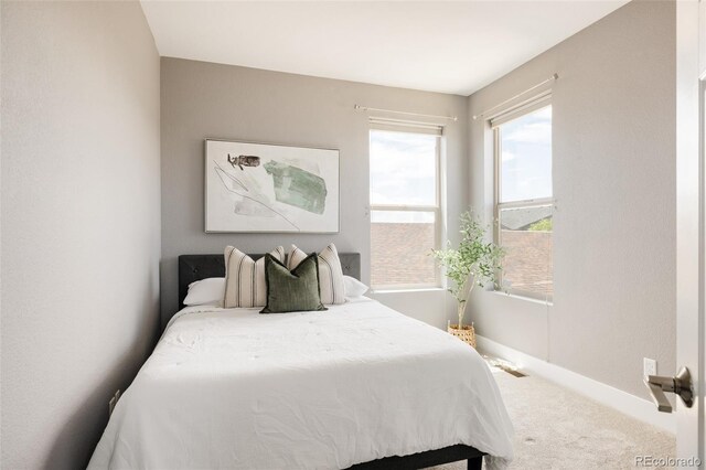 carpeted bedroom featuring baseboards