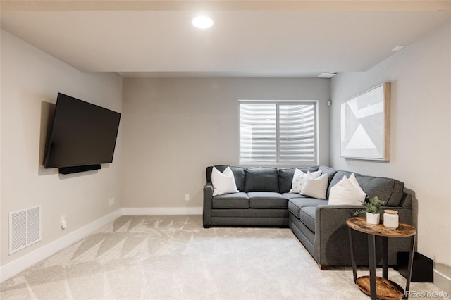 living area featuring visible vents, recessed lighting, baseboards, and light carpet