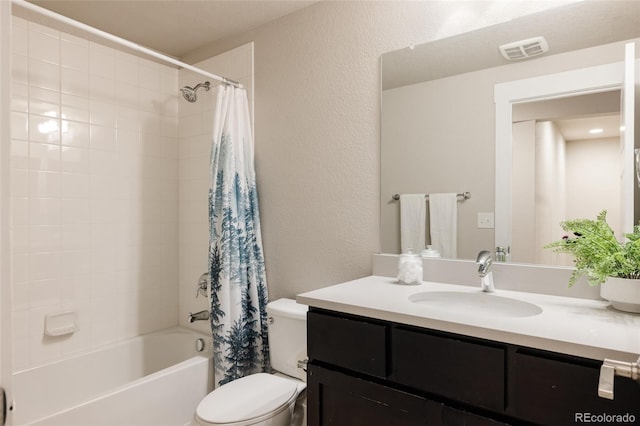 full bath featuring visible vents, vanity, toilet, a textured wall, and shower / bath combo with shower curtain