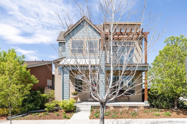view of front of home with a porch and a pergola