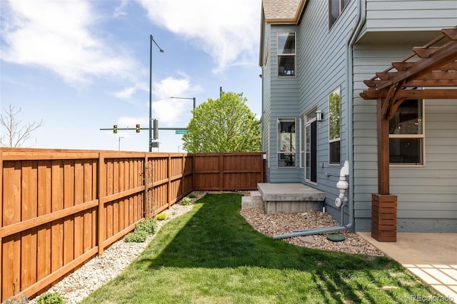 view of yard with a fenced backyard and a pergola
