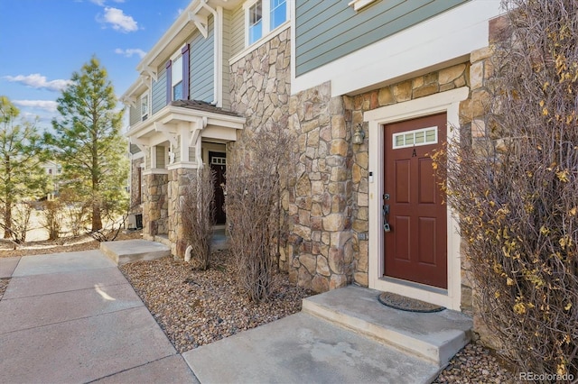 property entrance featuring stone siding