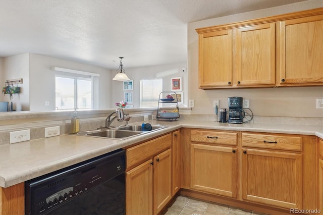 kitchen with black dishwasher, light countertops, a sink, and a peninsula