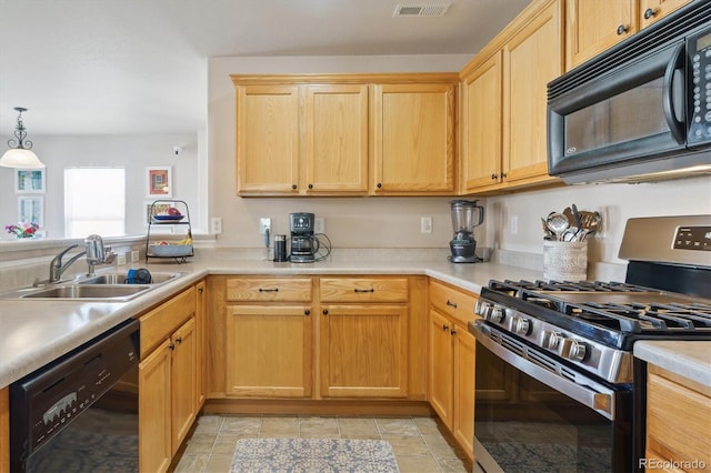 kitchen featuring light brown cabinets, visible vents, a sink, and black appliances