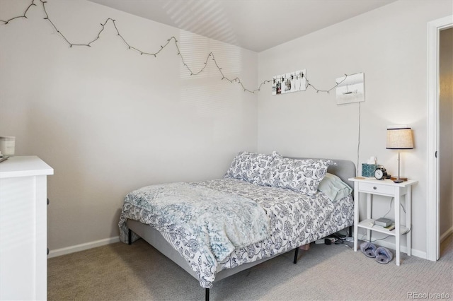 carpeted bedroom featuring baseboards