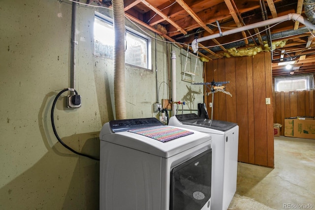 clothes washing area with a wealth of natural light and washer and dryer