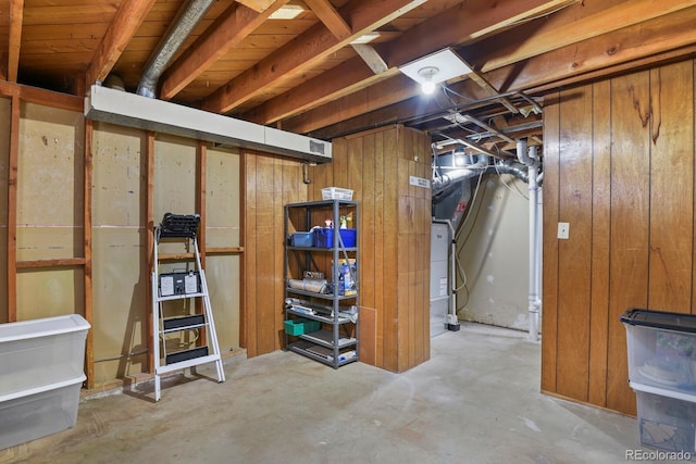 basement featuring wood walls