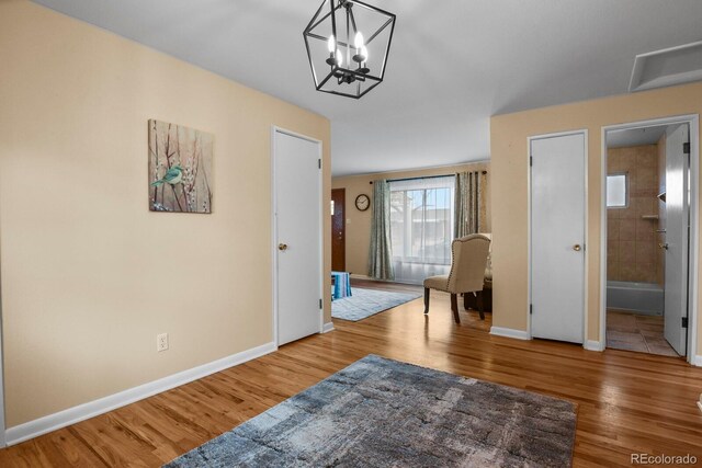 interior space with hardwood / wood-style flooring and a chandelier