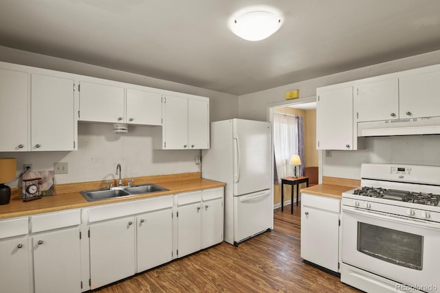 kitchen with white appliances, dark hardwood / wood-style flooring, sink, and white cabinets