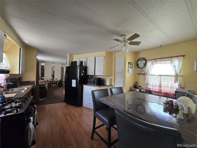 602 Vine St, Salida, CO 81201 - kitchen featuring black appliances, a sink, dark wood-type flooring, a textured ceiling, and ceiling fan