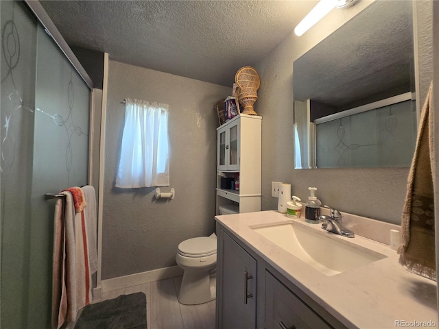 602 Vine St, Salida, CO 81201 - bathroom with a textured ceiling, vanity, toilet, an enclosed shower, and a textured wall
