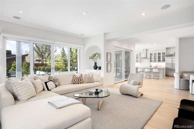 living room featuring light wood finished floors and recessed lighting