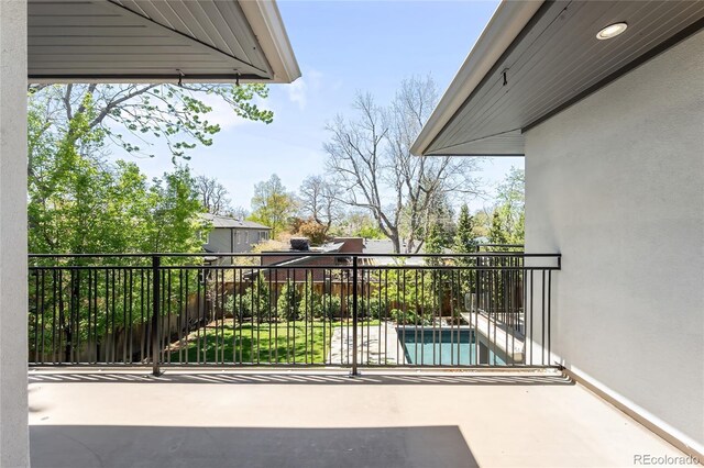 balcony featuring view of pool area