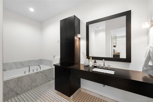 full bathroom featuring vanity and a bath