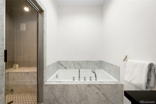 full bathroom with a stall shower and a bath