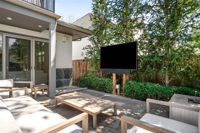 view of patio / terrace with fence and a balcony