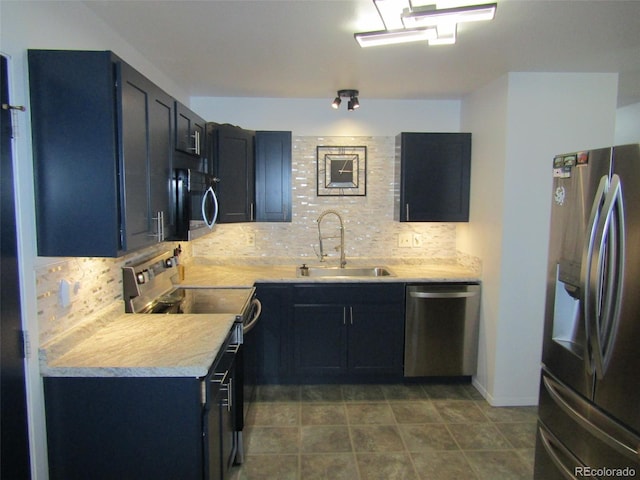 kitchen with tile patterned flooring, appliances with stainless steel finishes, tasteful backsplash, and sink