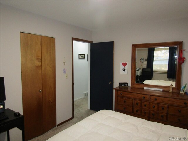 carpeted bedroom featuring a closet