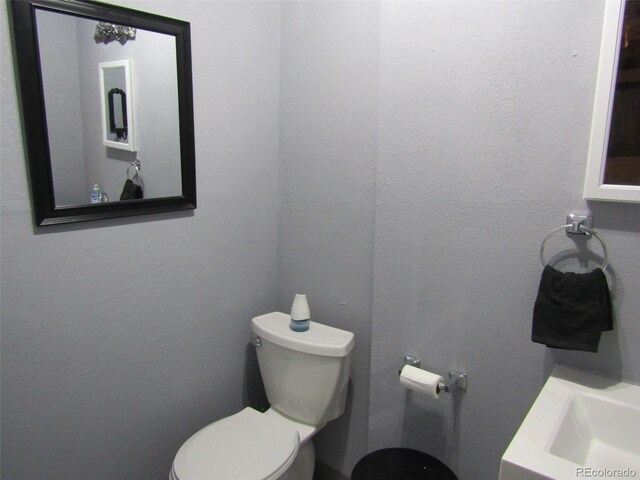 bathroom featuring toilet and sink