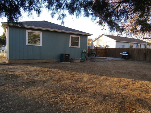 rear view of house featuring cooling unit