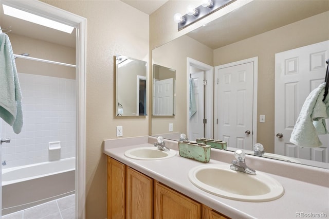 bathroom featuring a sink, shower / washtub combination, double vanity, and tile patterned flooring