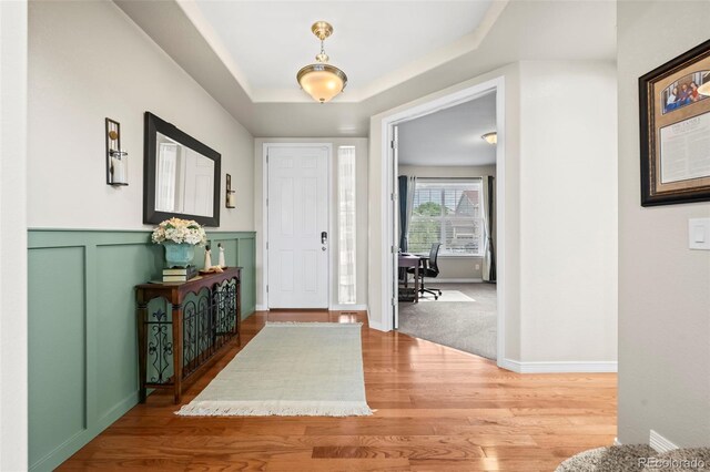9957 Quintero St, Commerce City, CO 80022 - foyer entrance featuring wood finished floors and wainscoting