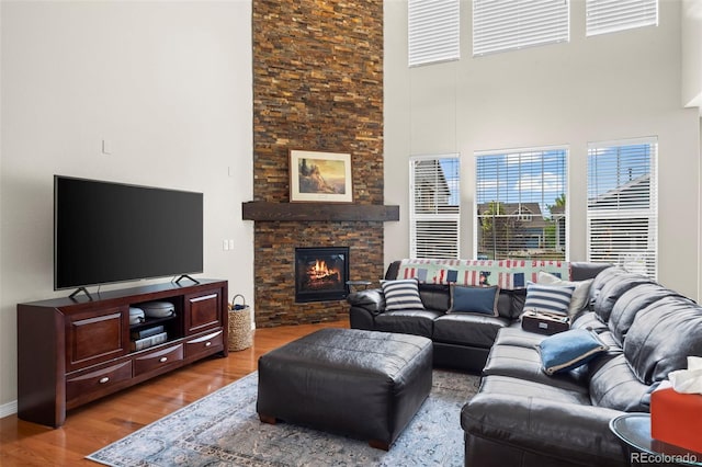 9957 Quintero St, Commerce City, CO 80022 - living area with a high ceiling, wood finished floors, and a fireplace