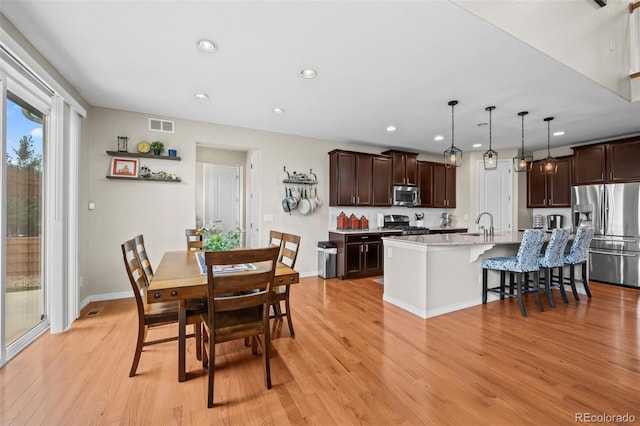 9957 Quintero St, Commerce City, CO 80022 - dining space featuring light wood finished floors and recessed lighting