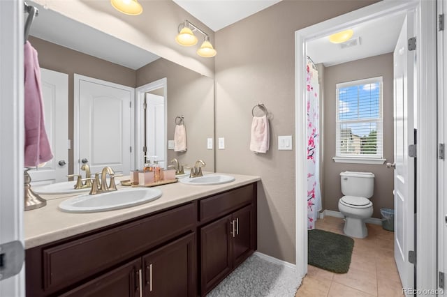 9957 Quintero St, Commerce City, CO 80022 - bathroom featuring double vanity and tile patterned flooring