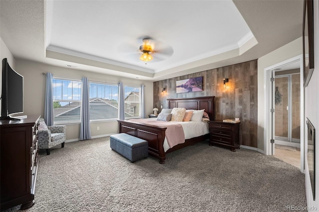 9957 Quintero St, Commerce City, CO 80022 - bedroom featuring a tray ceiling, light carpet, a ceiling fan, wood walls, and crown molding