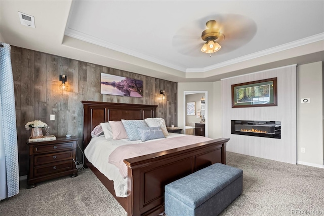 9957 Quintero St, Commerce City, CO 80022 - carpeted bedroom with a glass covered fireplace, a raised ceiling, crown molding, a ceiling fan, and connected bathroom