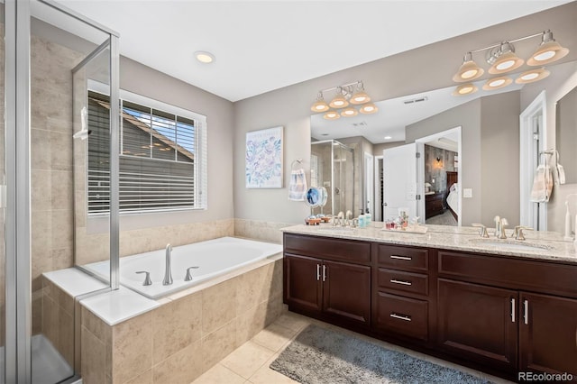 9957 Quintero St, Commerce City, CO 80022 - full bathroom with double vanity, a shower stall, tile patterned floors, a garden tub, and ensuite bath