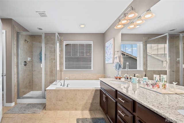 9957 Quintero St, Commerce City, CO 80022 - full bathroom featuring double vanity, tile patterned flooring, a bath, and a stall shower