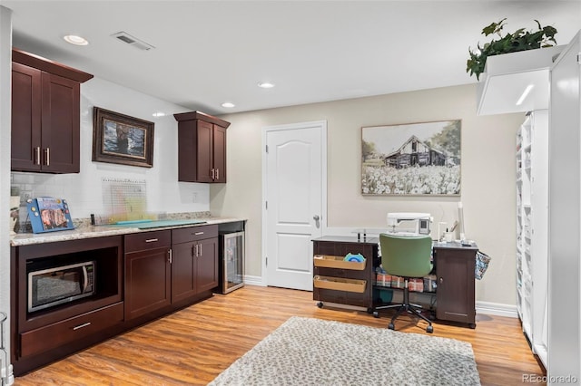 9957 Quintero St, Commerce City, CO 80022 - home office with wine cooler, light wood-style flooring, and recessed lighting